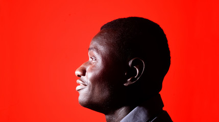 portrait of a african man on red background
