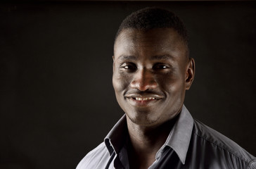 Fototapeta premium portrait of a african man on black