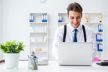 Young stylish businessman working in the office