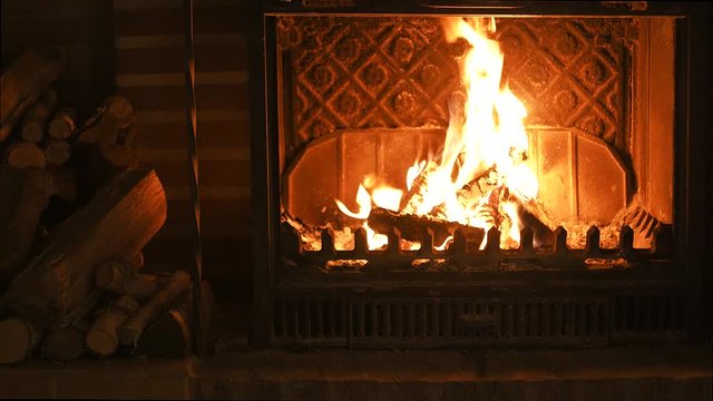 Burning fireplace with firewood. Video footage fire in fireplace - ideal for any holiday decoration. 