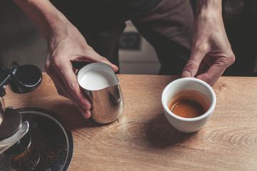 The barista prepare a cup of a latte. Easy toning