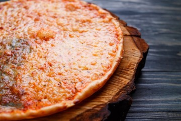 Appetizing quattro formaggi cheese pizza on wood, close up, selective focus. Italian food