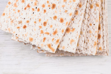 traditional Jewish kosher matzo for Easter pesah on a wooden table.