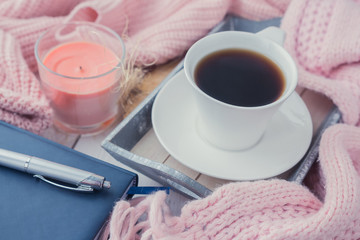  cup of coffee on a table in front of a window, the concept of breakfast and rest during work, a lifestyle of authentic, selective focus
