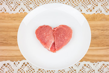 Raw meat in the shape of a heart.