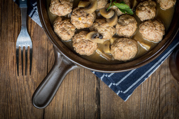 Delicious homemade swedish meatballs with mushroom cream sauce. Small depth of field. Top view.