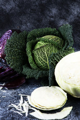 Obraz premium Three fresh organic cabbage heads. Antioxidant balanced diet eating with red cabbage, white cabbage and savoy