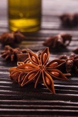 essential oil of the anise stars on a dark rustic background