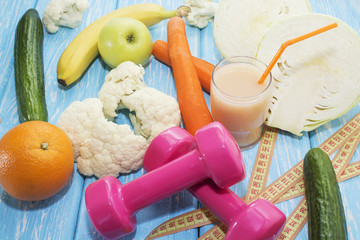 Fruits, vegetables, juice, smoothies and dumbbells health diet and fitness lifestyle concept.