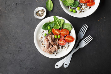 Healthy lunch. Tuna, wild rice and basmati, tomatoes, spinach and green peas in serving bowls. Top View.