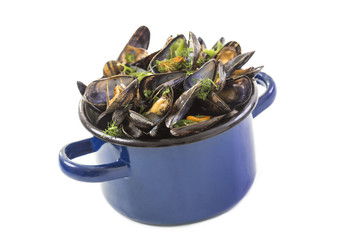 mussels in a blue ceramic pot on a white background. Healthy eating concept. Meditteranean lifestyle.