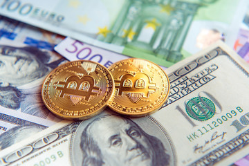 Two bitcoins on dollar and euro bills (Investment, exchange rate, wealth, luxury, success, stock exchange - concept)