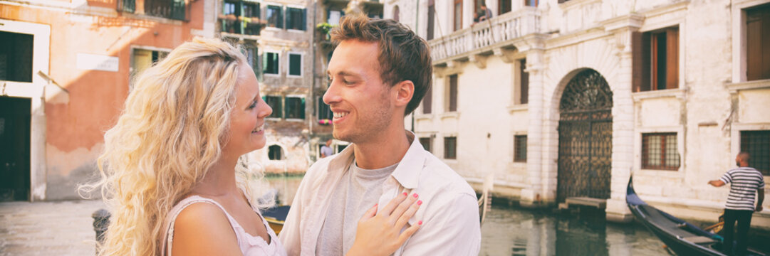 Romantic honeymoon couple in love walking in Venice streets. Lovers tourists in summer Italy travel. Blonde woman and man happy together on Europe vacation holidays. Banner panorama.