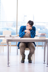 Student studying in the empty library with book preparing for ex