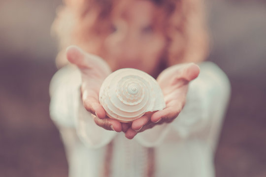 Beautiful Woman Out Of Focus Take A White Shell