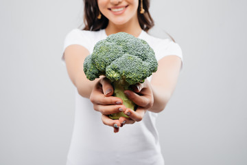 Fototapeta na wymiar Close up beautiful woman with broccoli, isolated on white background