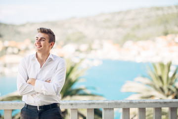 Smiling young person experiencing the reword for hard work,enjoying relaxed summer vacation at the resort.Happiness and sun.Successful man deserved vacation.Business and pleasure.Stress free.Relief