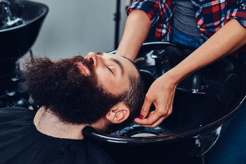 Handsome bearded man in the barbershop.
