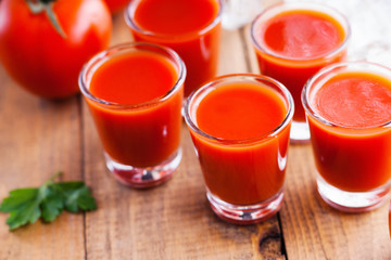 Cold Bloody Mary cocktail shot in glasses 