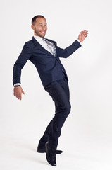 Businessman in a suit dances.
White background.
Isolated image.