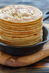 Cast iron pan with stack of fresh pancakes