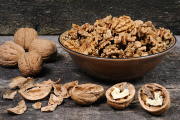 Walnuts without shell in a clay plate. Front view.