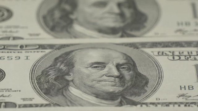 Hundred-dollar bills close-up, motion slider - 4. Macro photography of banknotes. Portrait of Benjamin Franklin.