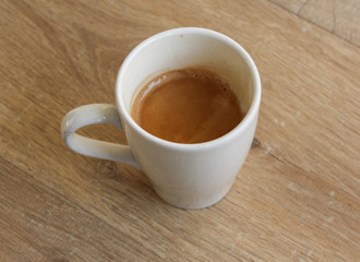 Cup of black coffee on wooden background