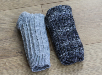 Homemade self knitted wool socks on wooden background