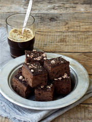Pieces of cake chocolate brownies on wooden background. Homemade baking. Copy space