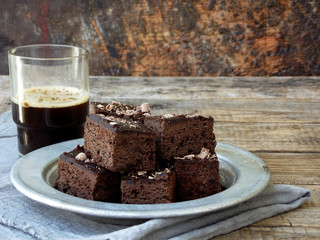 Pieces of cake chocolate brownies on wooden background. Homemade baking. Copy space
