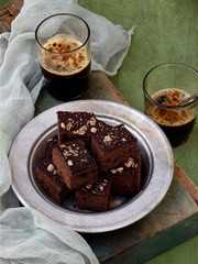 Pieces of cake chocolate brownies on wooden background. Homemade baking. Copy space