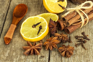 Dried herbs and seasoning. Star of anise, cinnamon sticks and cloves lying on wooden table, seasoning for cooking and baking.