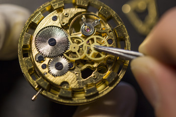 Watchmaker is repairing the mechanical watches in his workshop
