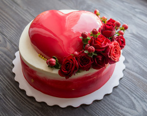 biscuit cake decorated with a mousse cake and flowers