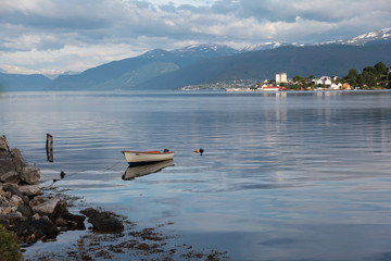 Fototapeta na wymiar A lonely boat in the Norwegian fjord