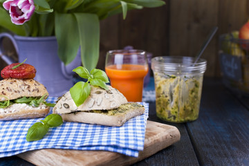 Bread with avocado, tomatoes and cheese on a blue towel and a board. Sandwiches for breakfast and juice. A healthy diet for a diet. Free space for text.