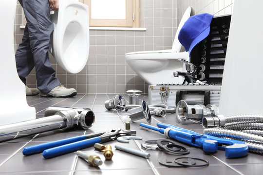hands plumber at work in a bathroom, plumbing repair service, assemble and install concept