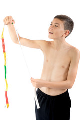 Teenage boy looking at a tape measure