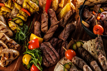 Assorted delicious grilled meat with vegetable. Mixed grilled bbq meat with vegetables. Mixed...