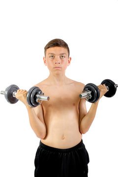Teenage boy exercising with dumbbells