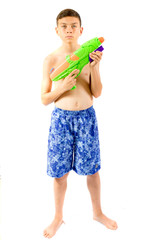 Young teenage boy playing with water guns