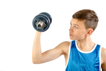 Young teenage boy using dumbbells