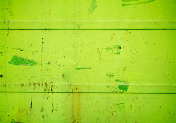 Green old rusty sheet with peeling paint background