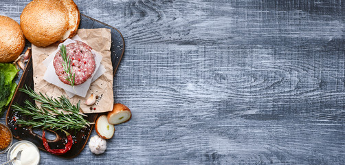 ingredients for a delicious homemade American burger with a juicy large beef chop