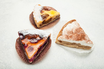Three beautiful delicious berry cake close-up on a white background.
