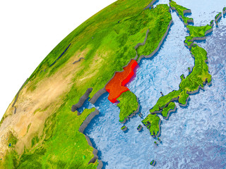 Map of North Korea in red on globe