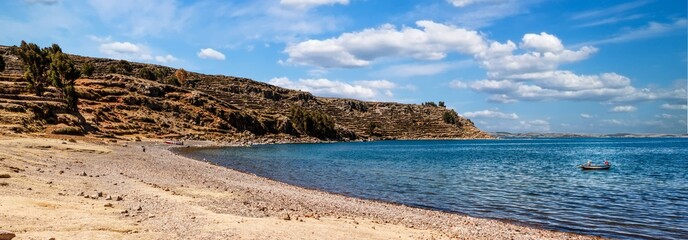 A beach in the Island of Amantani, with two fishermen, Titicaca Lake, Peru