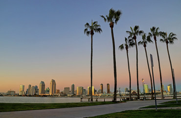 A view of San Diego, California from Coronado Island at dusk. - obrazy, fototapety, plakaty