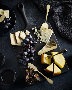 Various Cheeses On Board With Fresh Grapes 